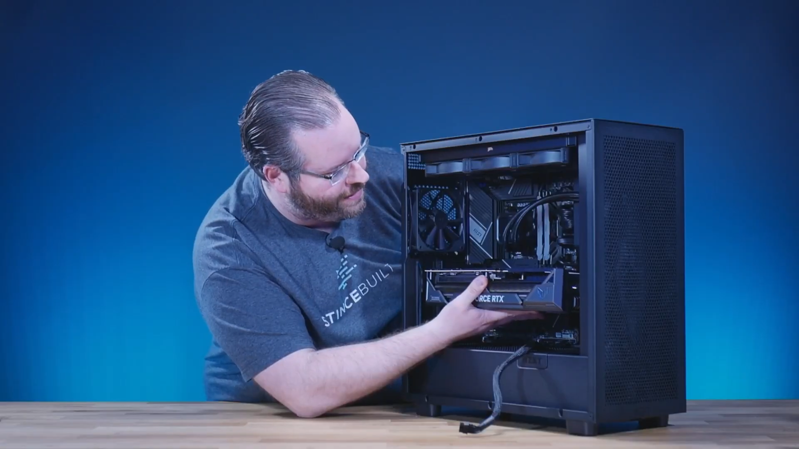 Seating graphics card into PCIe slot until latch clicks